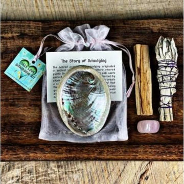 Self-love kit with abalone shell, Palo Santo, Rose Quartz and Sage Smudge STick on wooden table